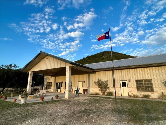 a patio with a table and chairs under an umbrella