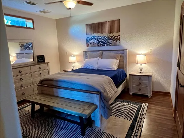 a bedroom with a bed and a chandelier