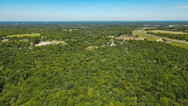 an aerial view of residential houses with outdoor space and river