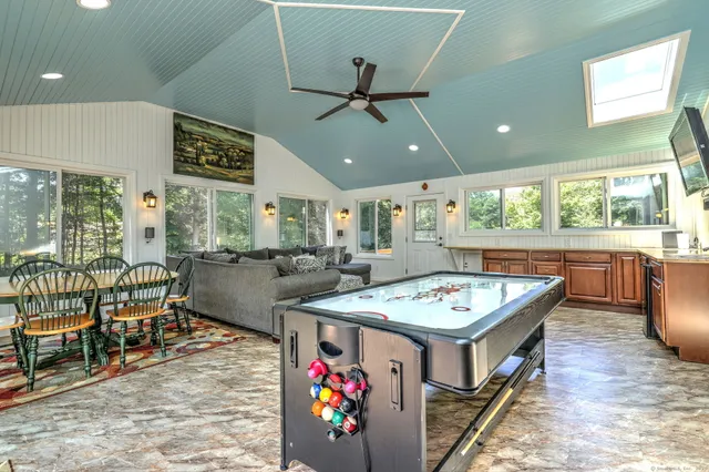 a living room with furniture and a open to kitchen view