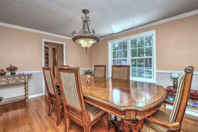a dining room with furniture and window