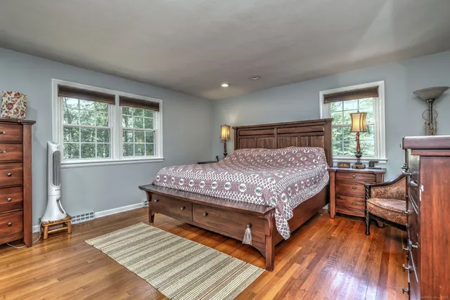 a bed sitting in a bedroom next to a window