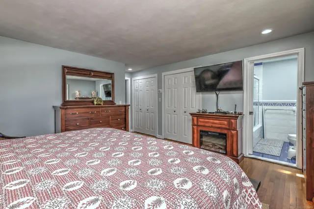 a bedroom with a bed and a dresser