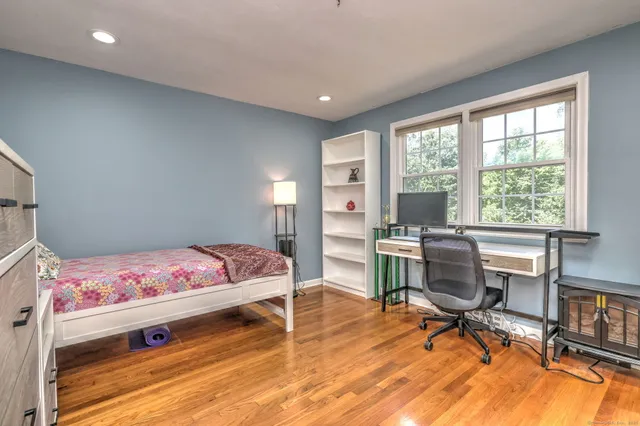 a bedroom with a bed and a desk