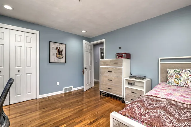 a room with a bed and a dresser