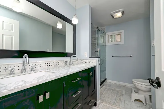 a bathroom with a double vanity sink and a mirror