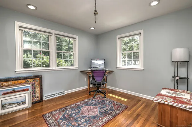 a room that has a window and a table in it