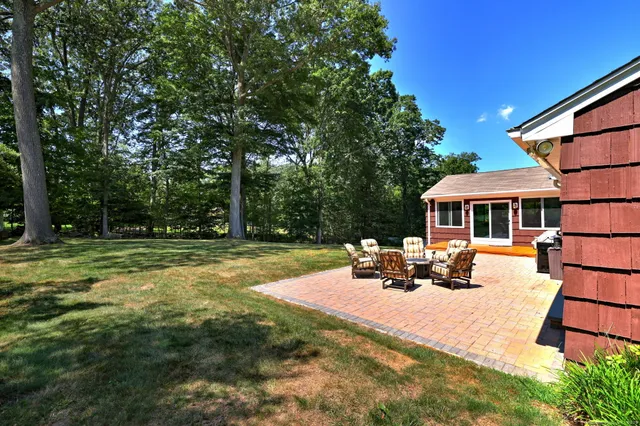 a view of a house with backyard porch and sitting area