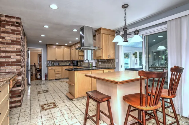 a open kitchen with stainless steel appliances granite countertop a sink and a refrigerator