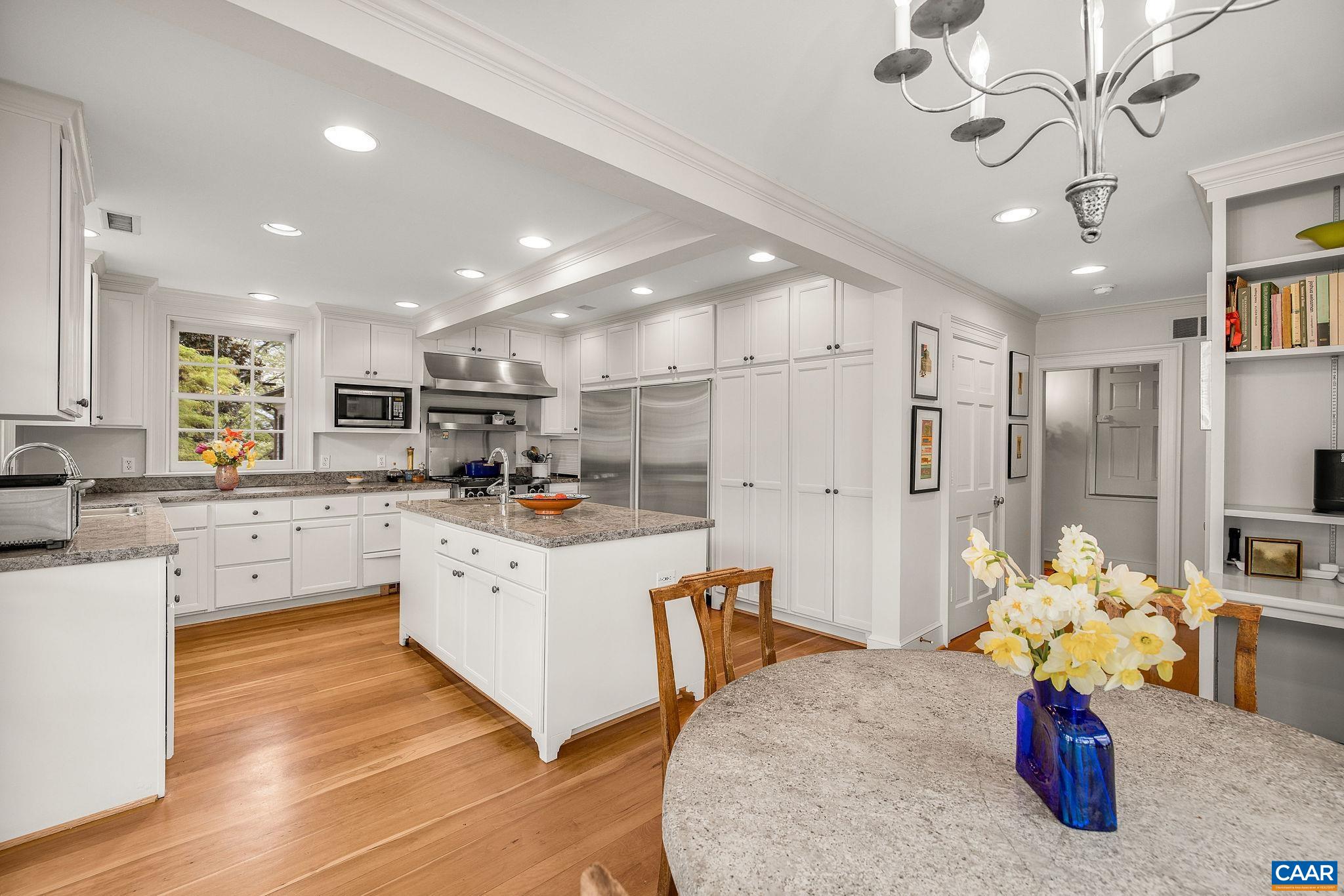 1985 Stony Point Road Charlottesville, VA 22911 - Photo 16 of 62 a kitchen with stainless steel appliances kitchen island granite countertop a refrigerator a sink dishwasher a stove and white cabinets with wooden floor