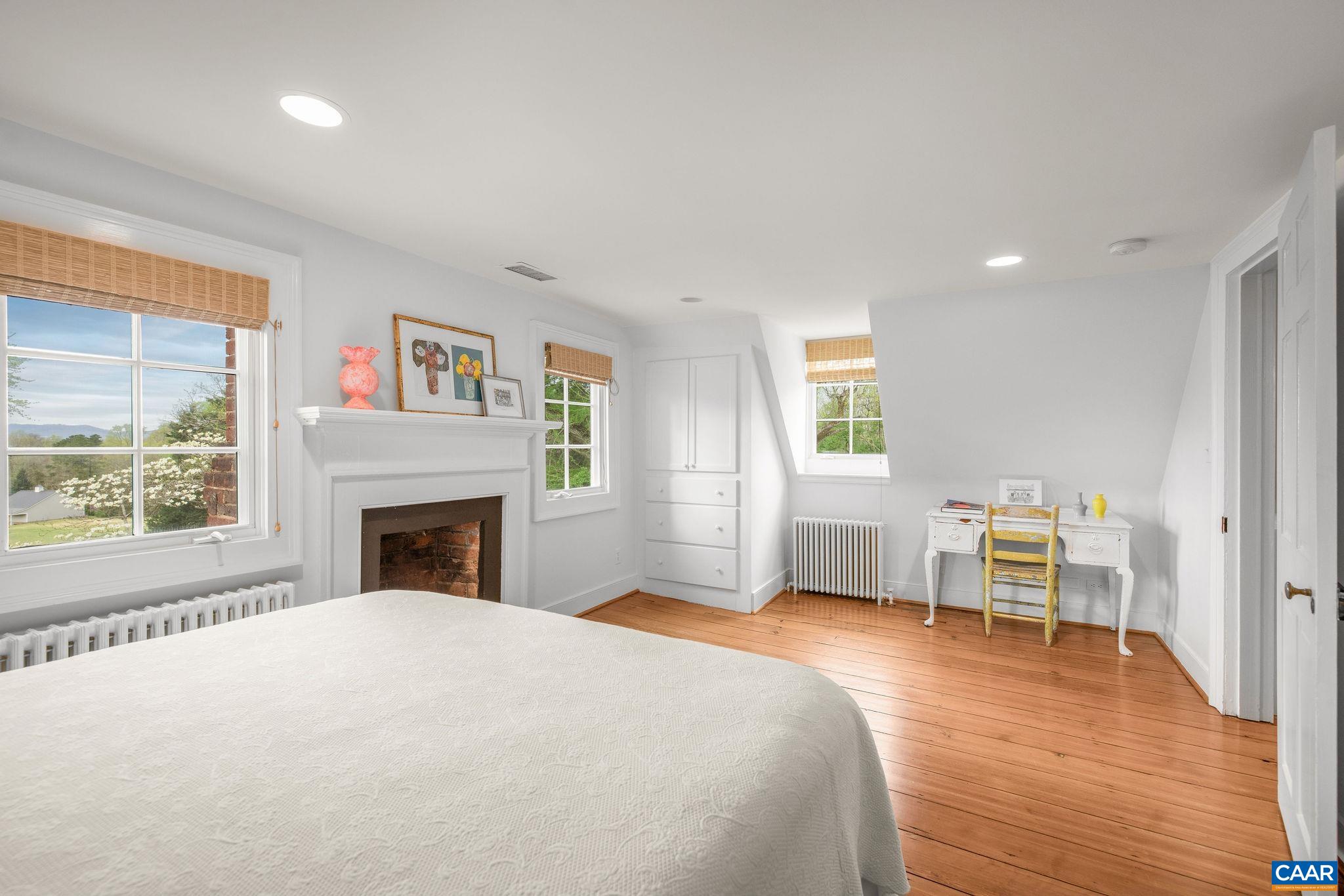 1985 Stony Point Road Charlottesville, VA 22911 - Photo 33 of 62 a spacious bedroom with a large bed and a table chair