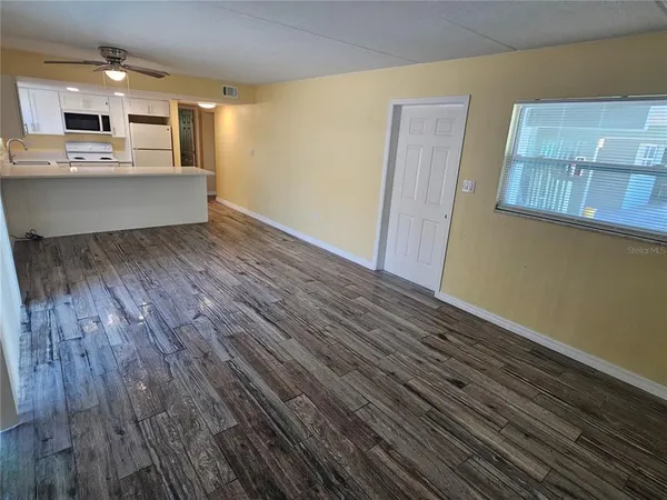 a view of kitchen with cabinets and wooden floor