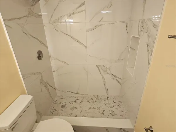 a bathroom with a toilet and shower