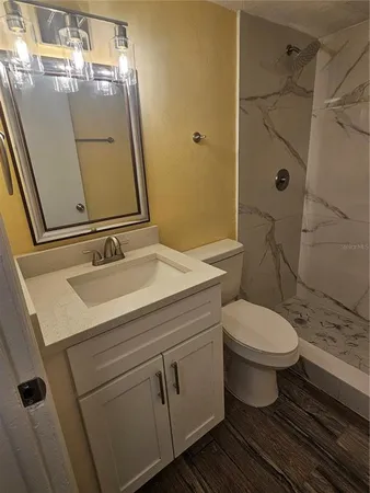 a bathroom with a sink toilet and shower