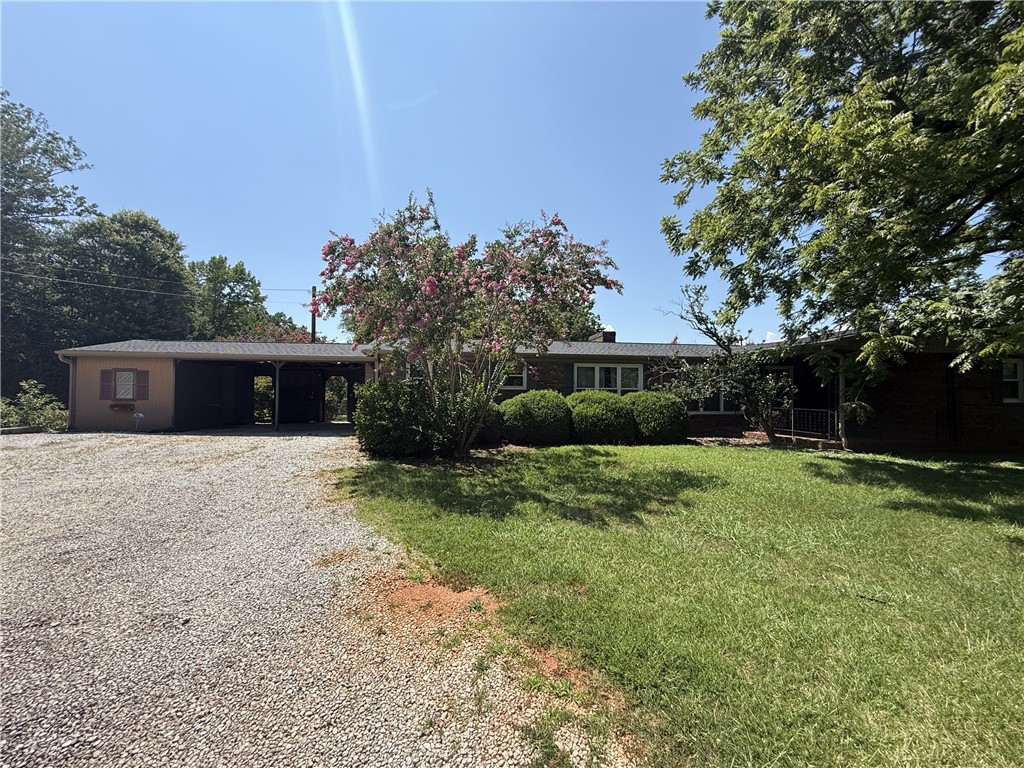 238 State Rd S-37-435 Westminster, SC 29693 - Photo 1 of 9 A welcoming home with a covered carport and verdant landscaping beckons.