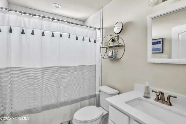 a utility room with dryer washer and a wooden floor