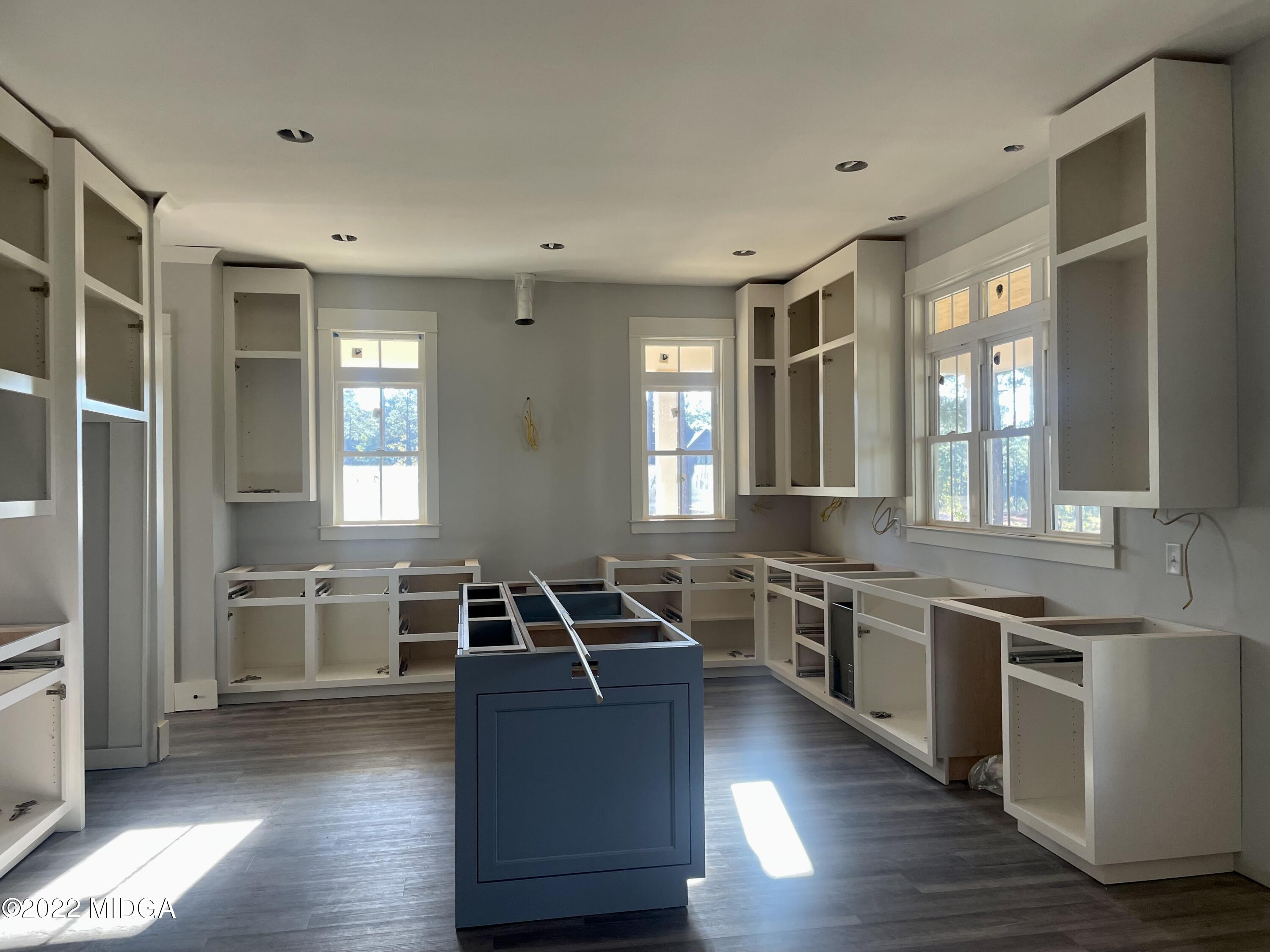 687 Edge Road Forsyth, GA 31029 - Photo 6 of 16 a kitchen with a sink stove and cabinets