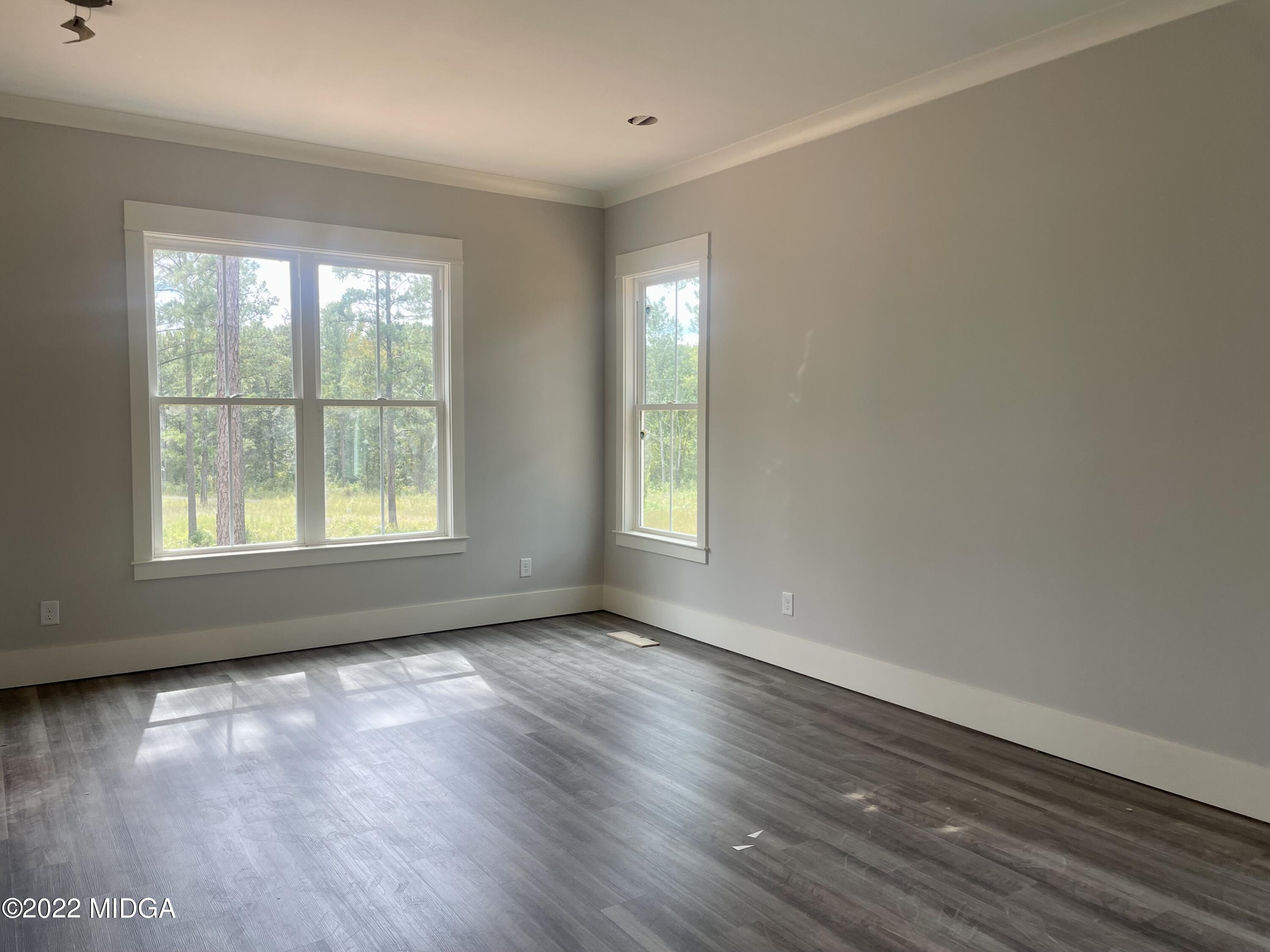 687 Edge Road Forsyth, GA 31029 - Photo 10 of 16 an empty room with wooden floor and windows