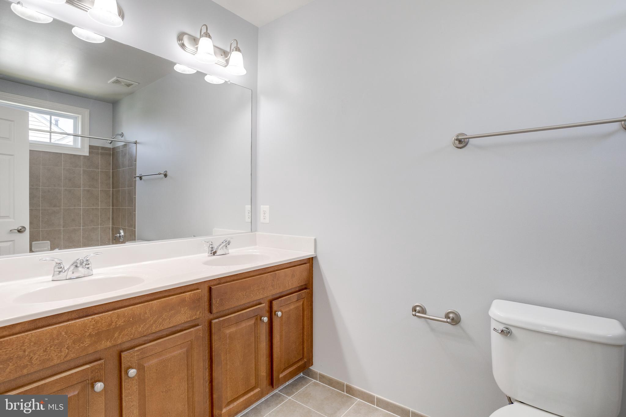 18475 Kerill Road Triangle, VA 22172 - Photo 69 of 99 a bathroom with a sink a toilet and a mirror