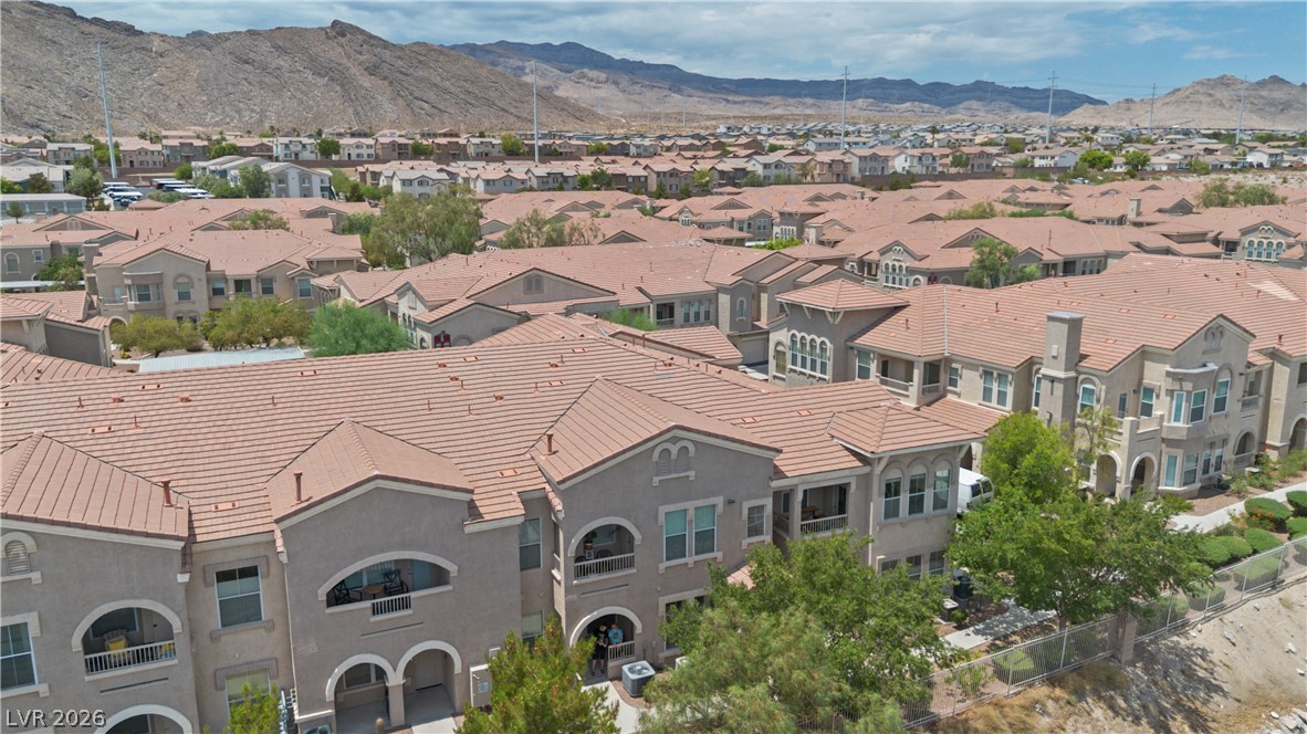 10550 West Alexander Road, Unit 1025 Las Vegas, NV 89129 - Photo 26 of 42 An aerial perspective reveals a dense residential community nestled against a rugged mountainous backdrop.