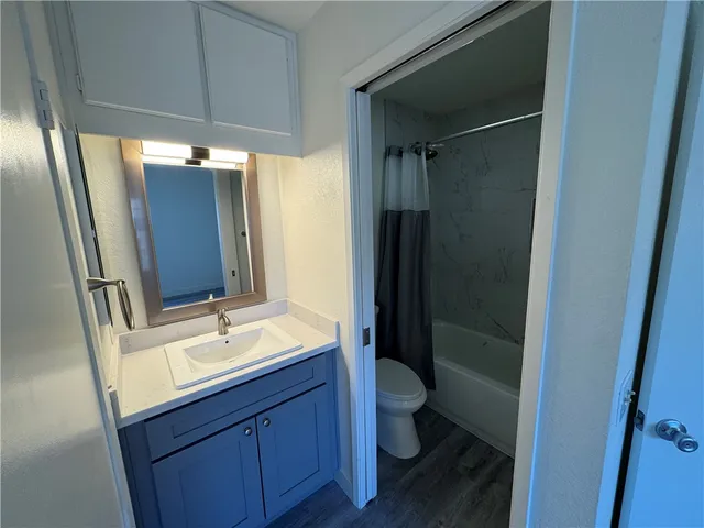 a bath tub sitting next to a white toilet and sink