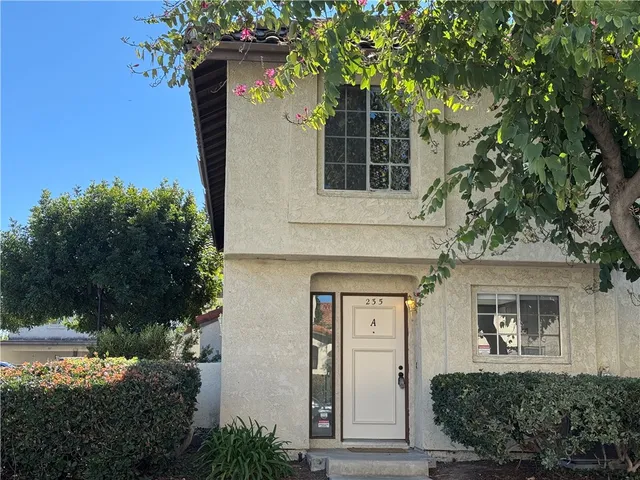 a front view of a house with a yard garage and outdoor seating