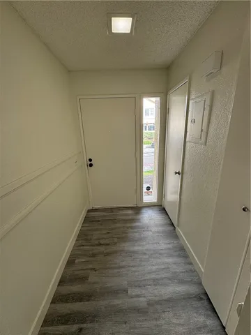 a view of entryway and hall with wooden floor