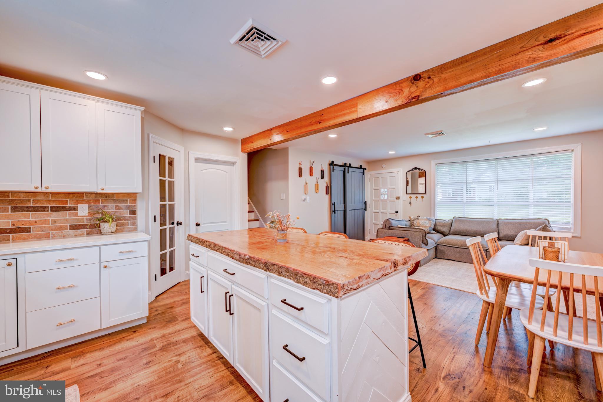 215 Murray Drive Doylestown, PA 18901 - Photo 9 of 29 a large white kitchen with granite countertop a stove a sink a dining table and chairs
