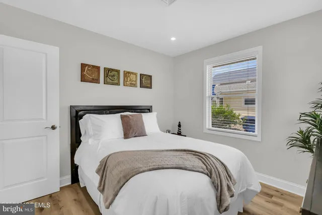 a large bed sitting in a bedroom next to a window