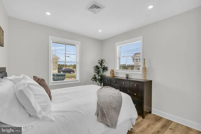 a spacious bedroom with a bed and a window