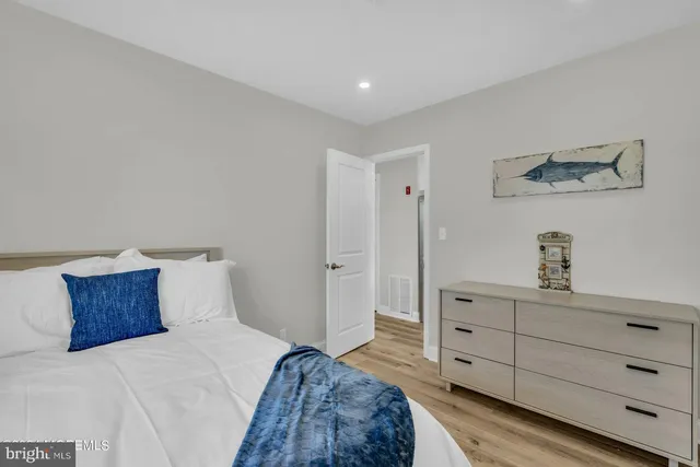 a bedroom with a bed and a dresser