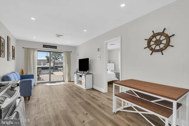 a room with furniture a flat screen tv and a window