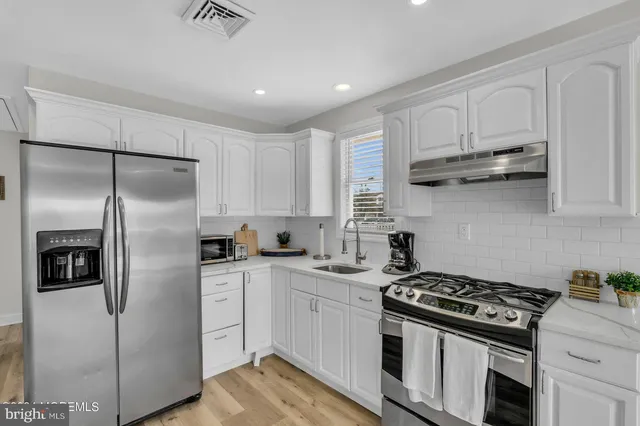 a kitchen with stainless steel appliances granite countertop a stove a refrigerator and a refrigerator