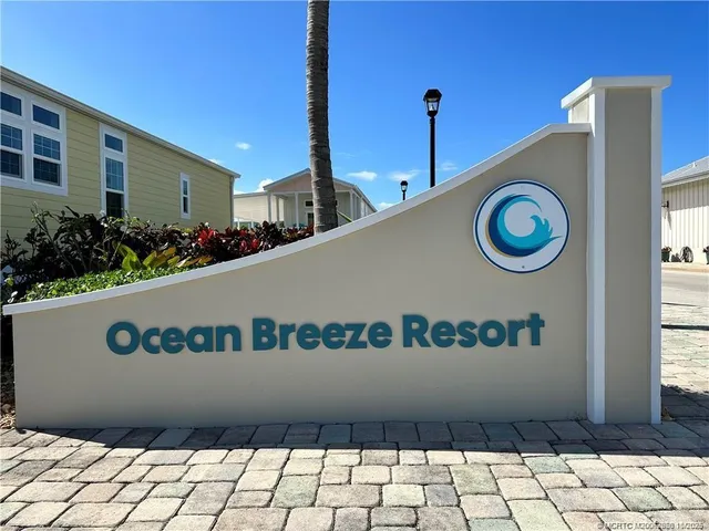 a view of a hallway with dining room and chandelier
