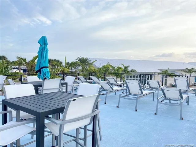 a view of a patio with a table and chairs