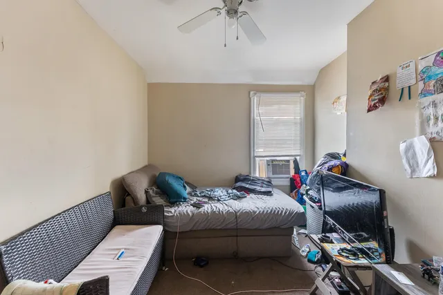 a bed room with a bed and a window