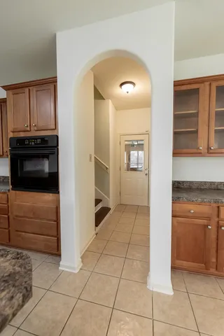 a view of kitchen with refrigerator and cabinets