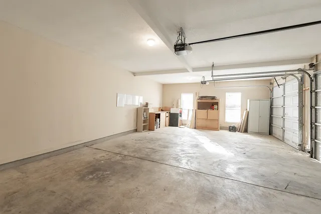 a big room with chandelier and windows