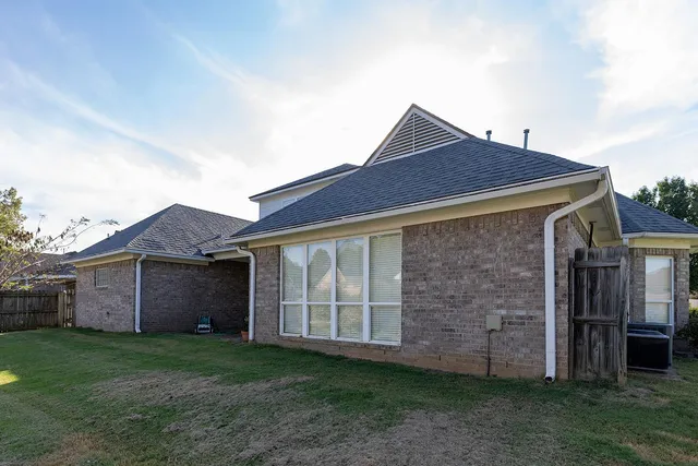 a front view of house with a garden