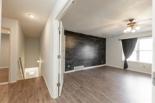 wooden floor in an empty room with a window