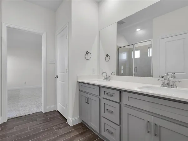 a bathroom with double sink and a mirror