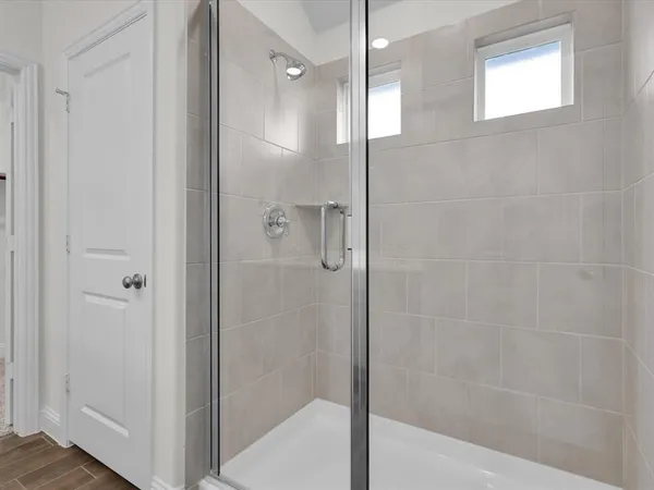a bathroom with a glass shower door