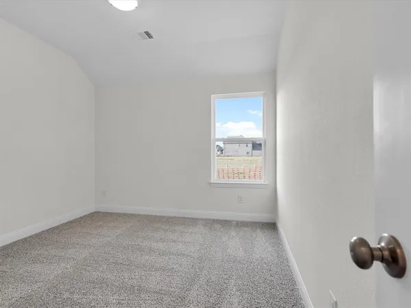a view of an empty room and a window
