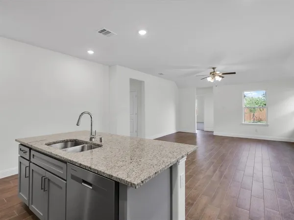 a kitchen with a sink and chandelier