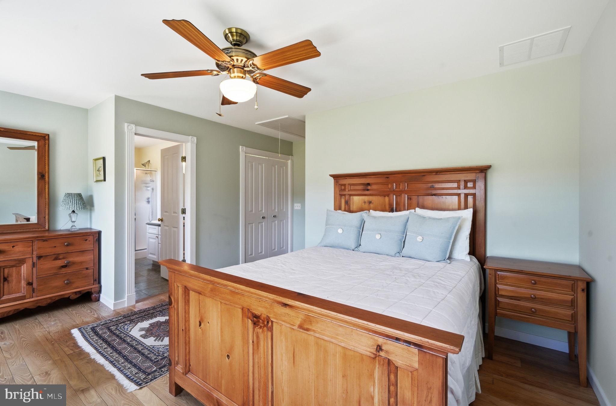 26226 Langs Landing Road Oxford, MD 21654 - Photo 25 of 48 a bedroom with a bed and a dresser