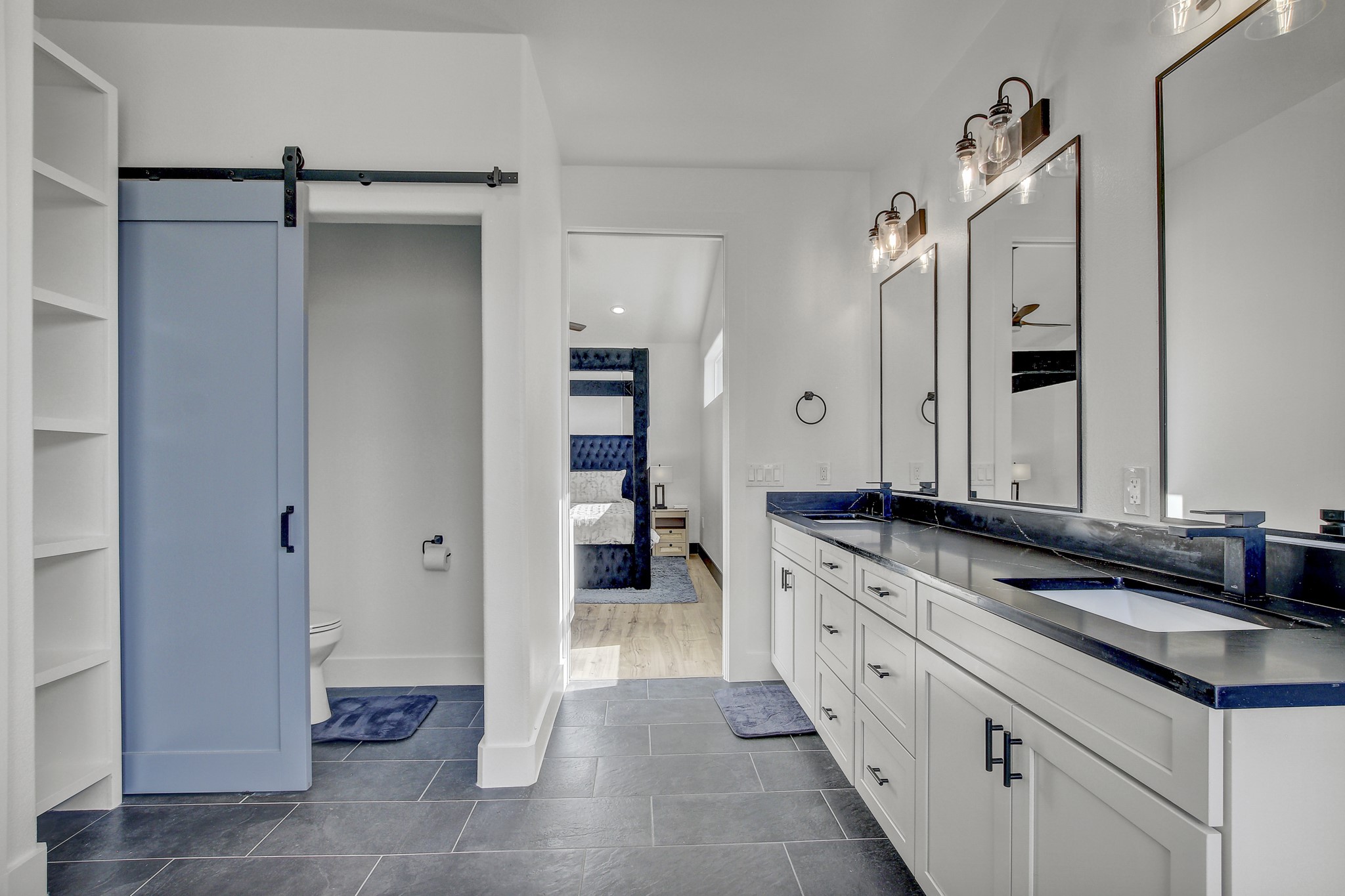 4703 Louis Avenue, Unit A Austin, TX 78721 - Photo 23 of 35 Bathroom with double vanity, ensuite bathroom, and dark tile patterned floors