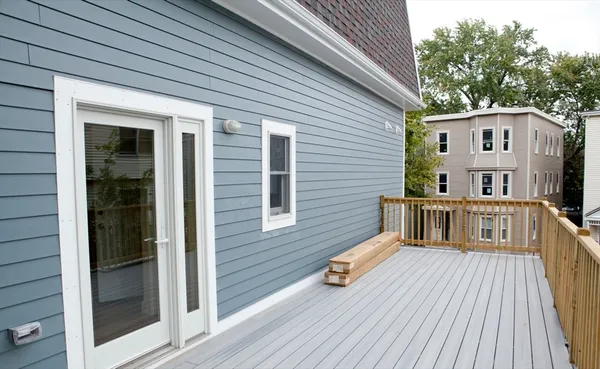 a view of a house with wooden deck