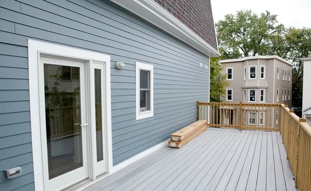 a view of a house with wooden deck