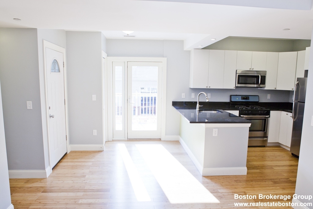 35 Forbes Street, Unit 2 Boston, MA 02130 - Photo 2 of 11 a kitchen with a sink and a stove top oven