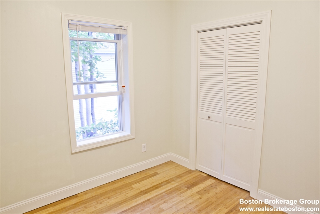 35 Forbes Street, Unit 2 Boston, MA 02130 - Photo 4 of 11 a view of an empty room with wooden floor and a window